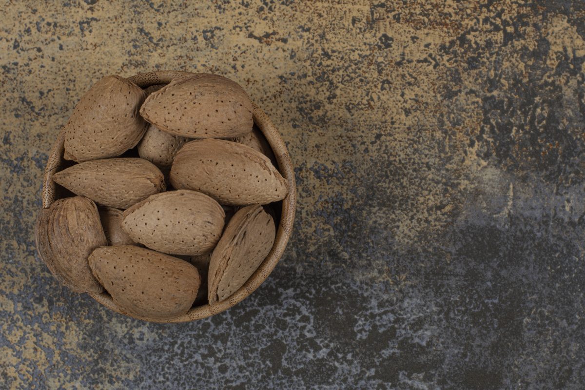 Shelled almonds in a wooden bowl