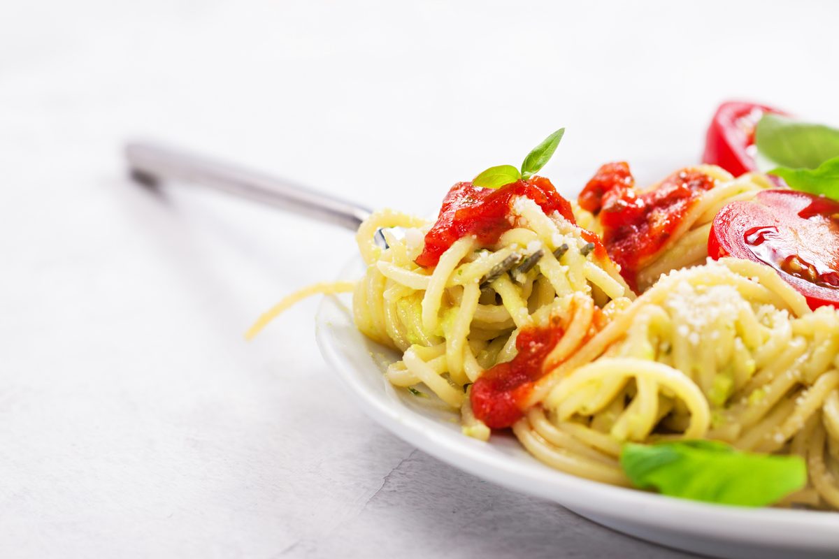 Plate of spaghetti with tomato sauce, basil and parmesan