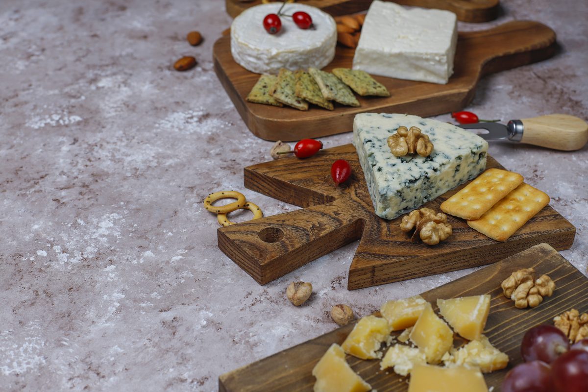 Assortment of cheeses on wooden boards
