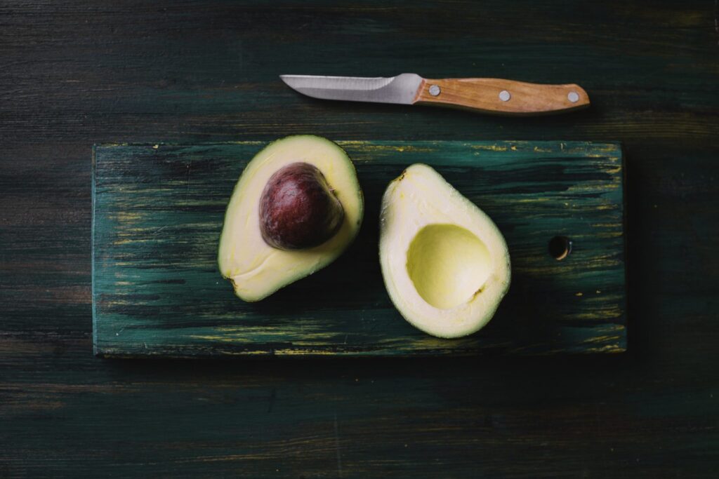 Halved avocados on a chopping board