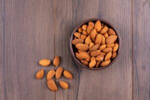 Bowl of almonds on a wooden table