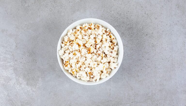 Bowl of freshly popped popcorn on a marble worktop