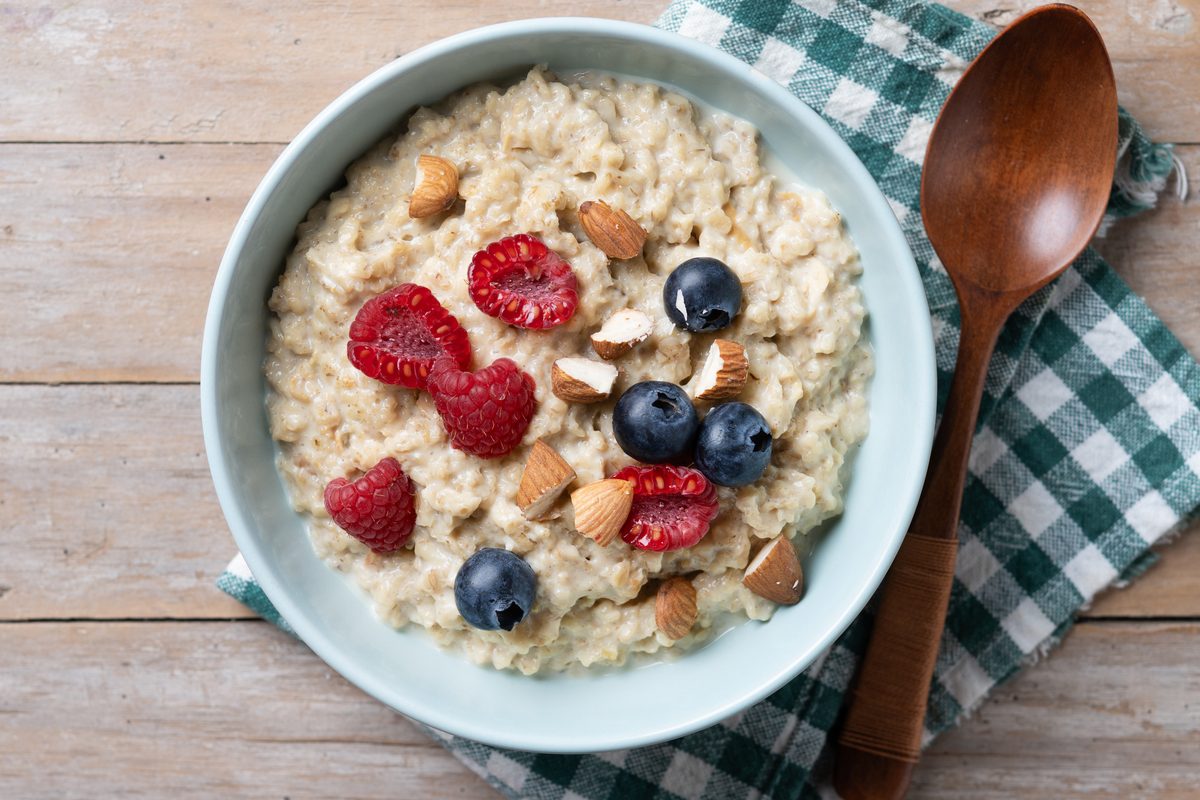 Bowl of oat porridge with raspberries, blueberries and almonds