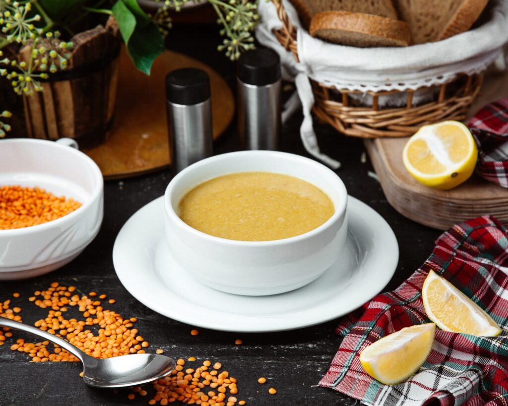 Bowl of lentil soup served with lemon