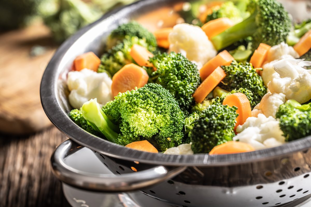Broccoli, carrots and cauliflower steamed in a stainless steel steamer