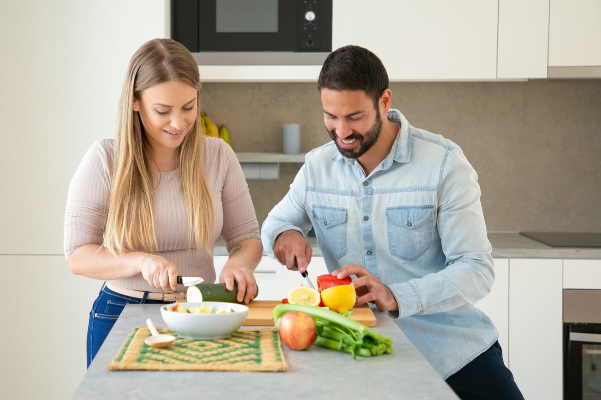 Couple preparing fresh vegetables together in the kitchen