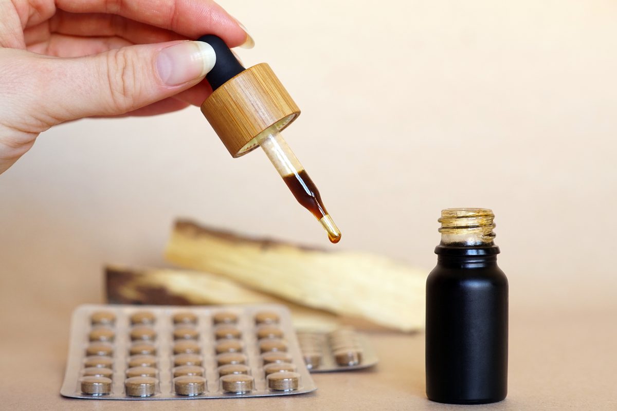 Dropper bottle and blister pack of tablets on a table