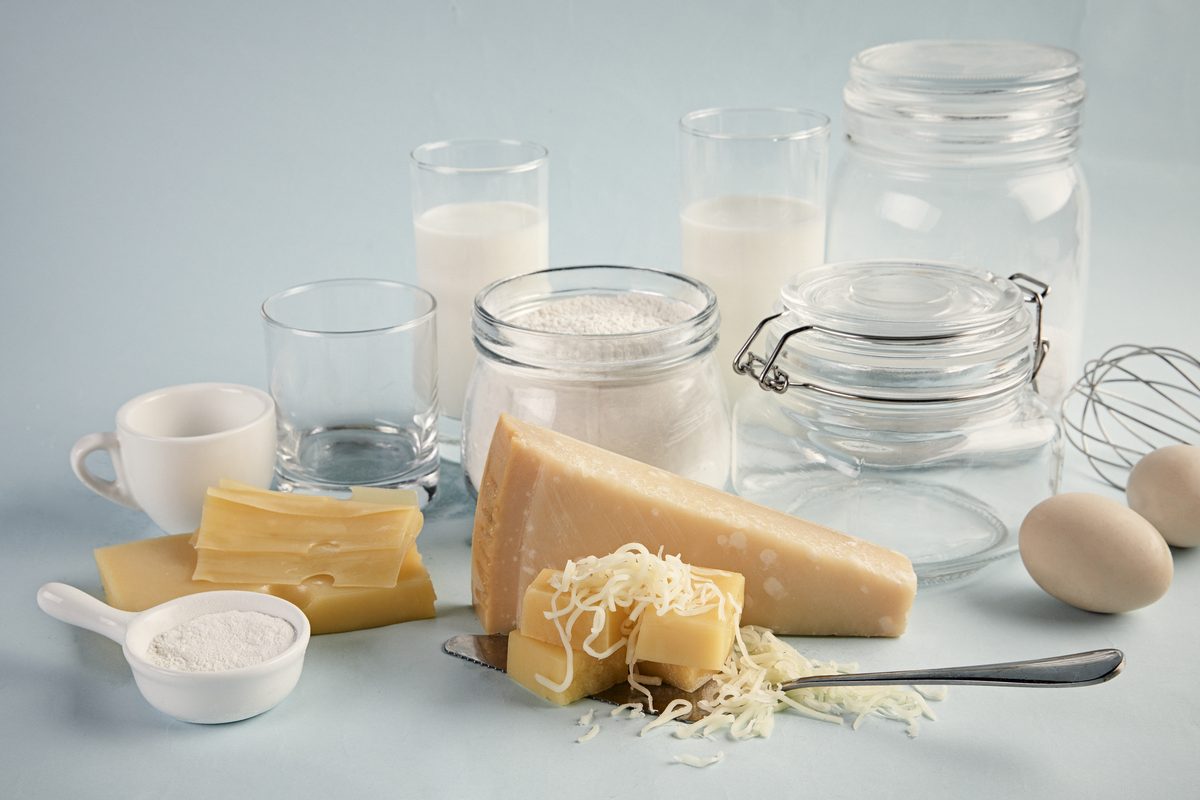 Cheeses, milk bottles and eggs on a light table