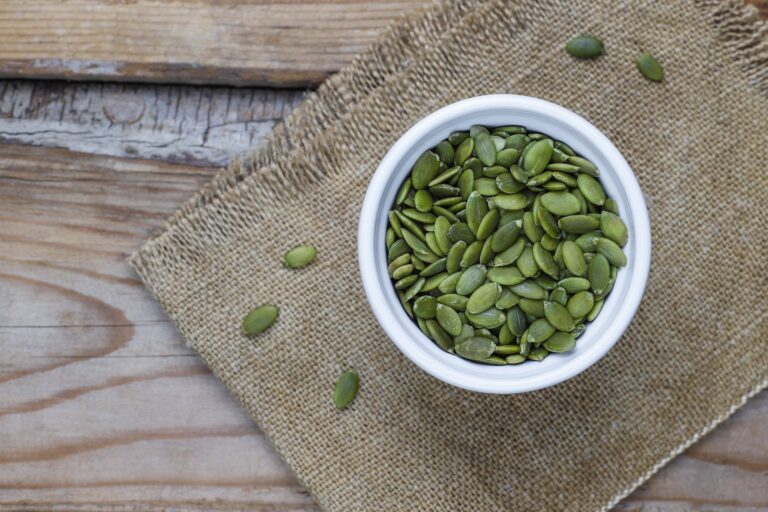 Pumpkin seeds in a bowl on hessian