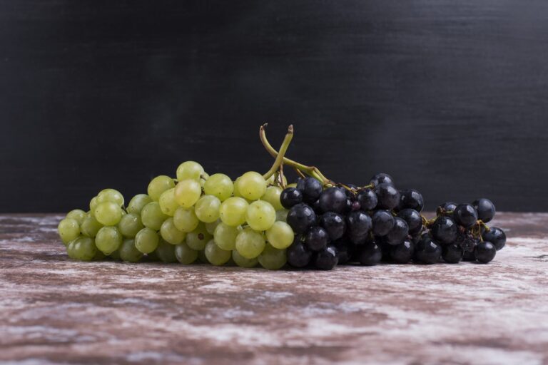 Bunches of white and black grapes on a table