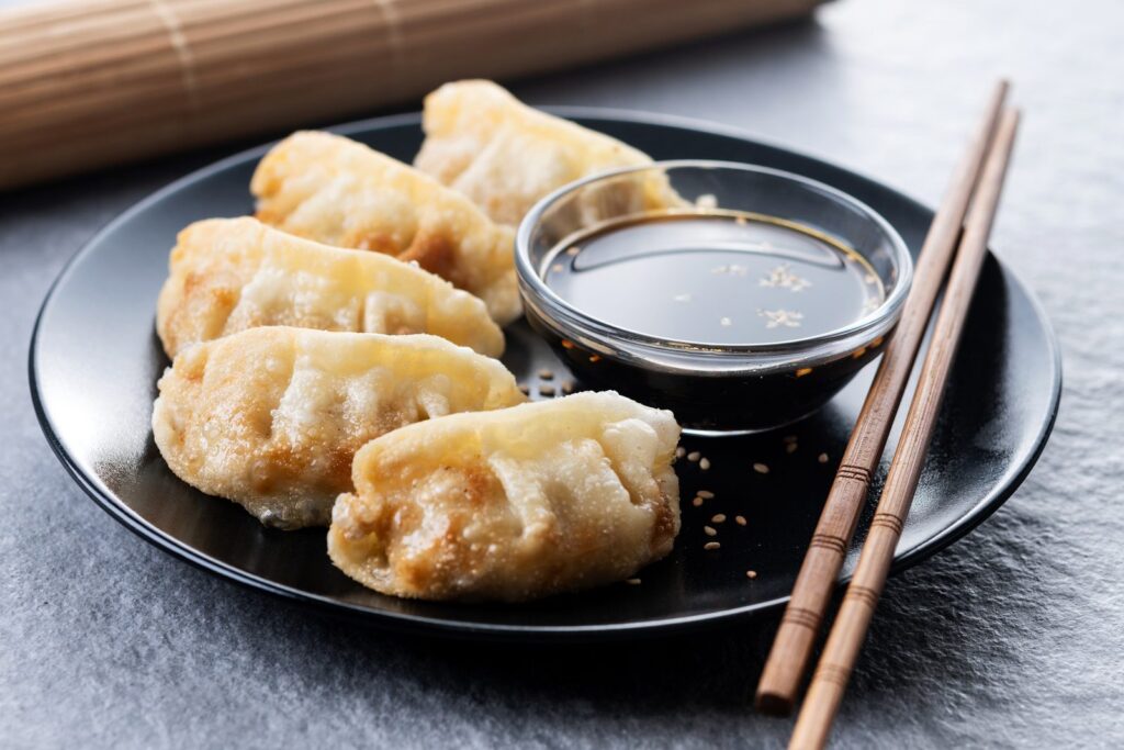 Pan-fried gyoza on a grey stone background