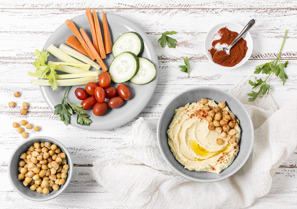 Hummus served with carrot sticks, cucumber and cherry tomatoes