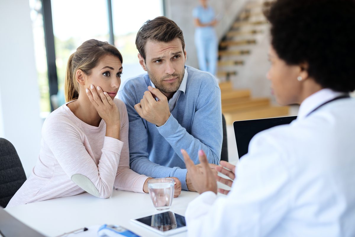 Young couple at a consultation with a female doctor