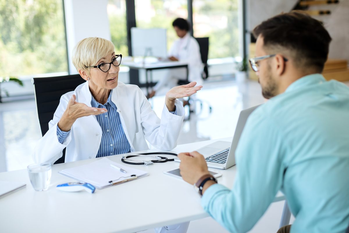 Doctor in a white coat in consultation with a patient