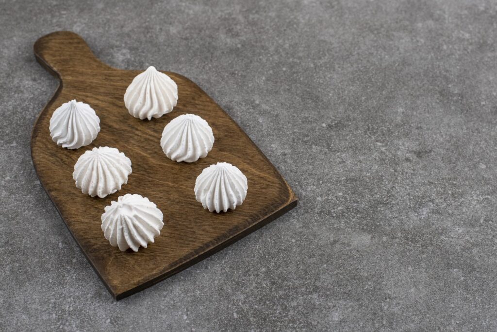 White meringues on a wooden board
