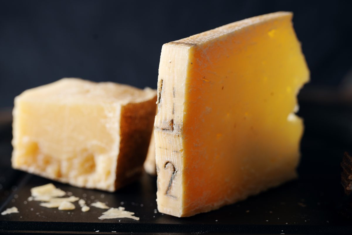 Pieces of matured Parmesan on a dark background