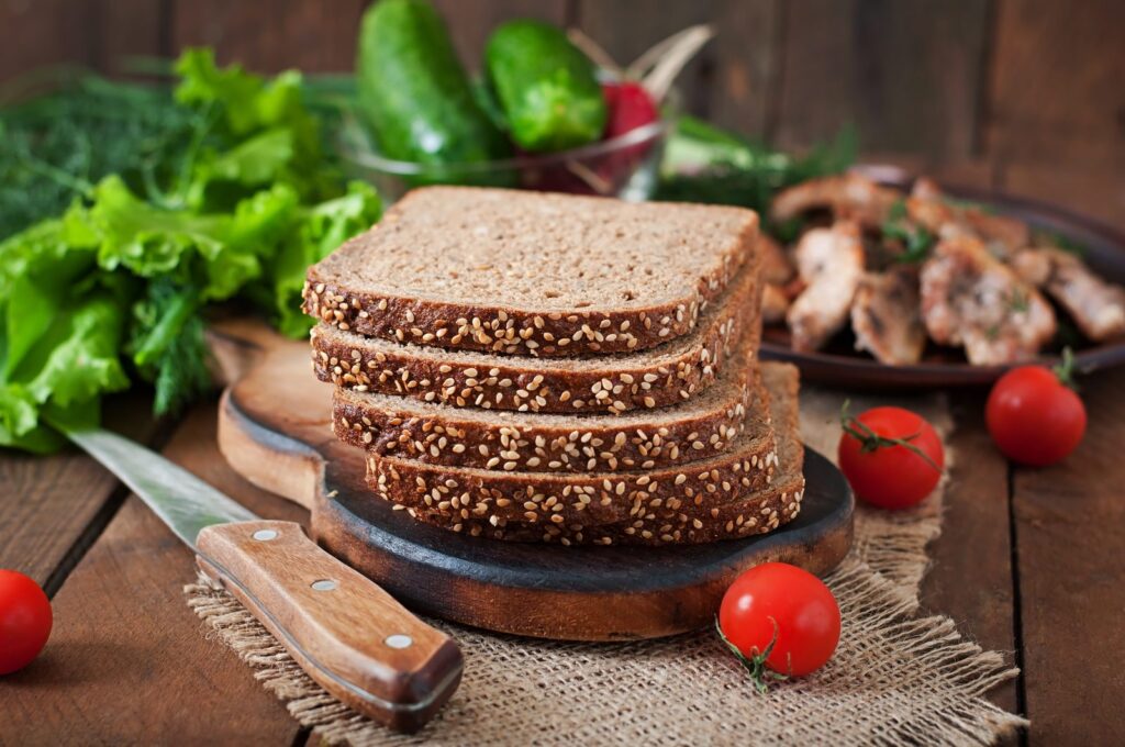 Sliced wholemeal rye bread with seeds on a wooden table