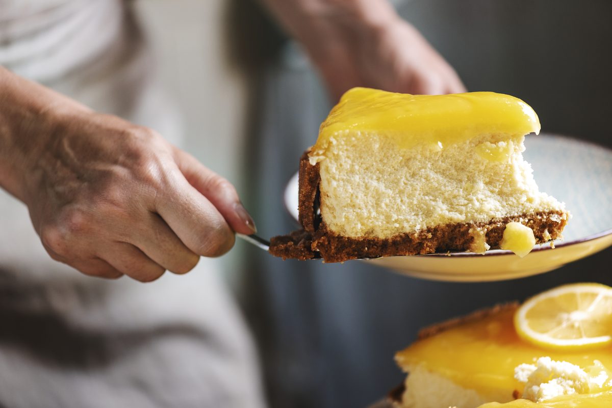 Slice of baked lemon cheesecake served on a cake server