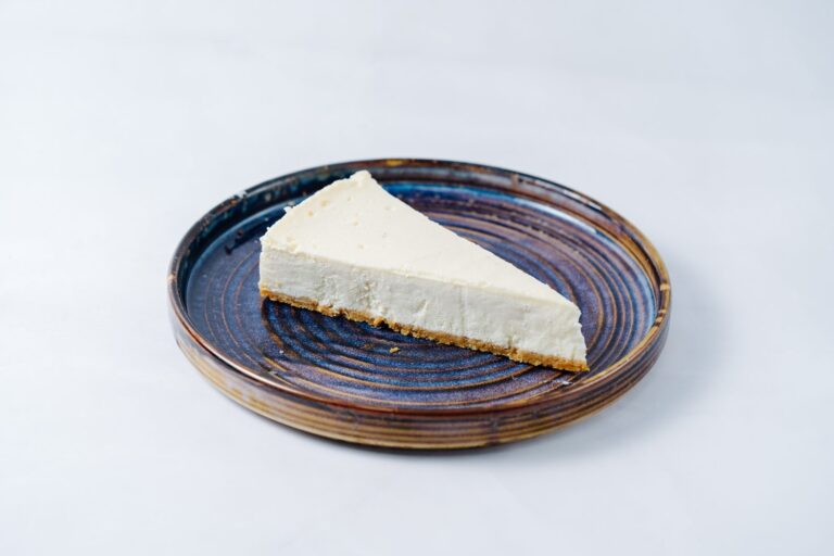Slice of plain cheesecake served on a plate