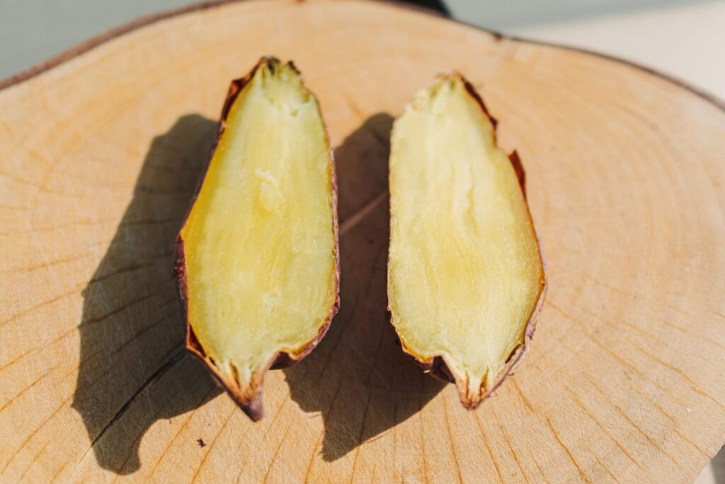 Halved sweet potato on a wooden board