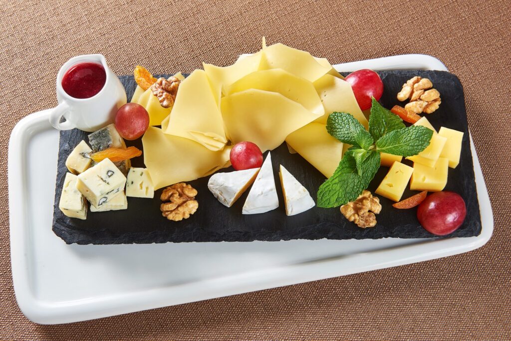 Cheese platter with grapes and walnuts