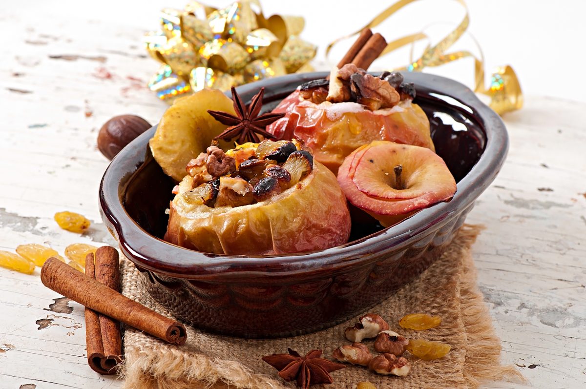 Baked apples stuffed with raisins, walnuts and honey in a dish