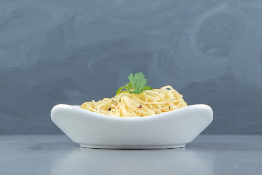 Portion of cooked spaghetti in a white bowl