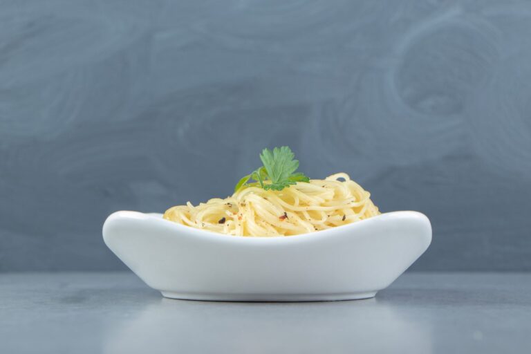 Portion of cooked spaghetti in a white bowl