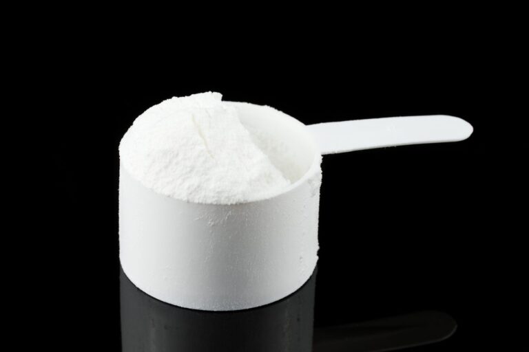 Weight-gainer powder for athletes in a scoop