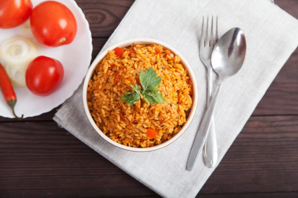 Jollof rice with tomato and chilli on a blue plate