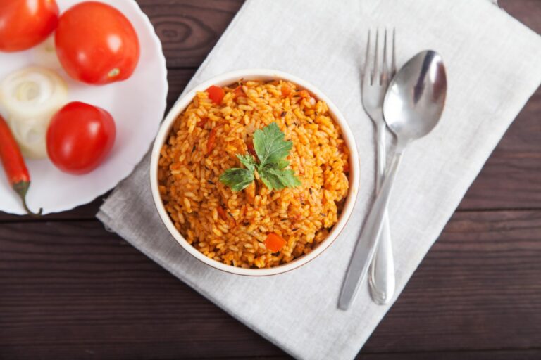 Jollof rice with tomato and chilli on a blue plate