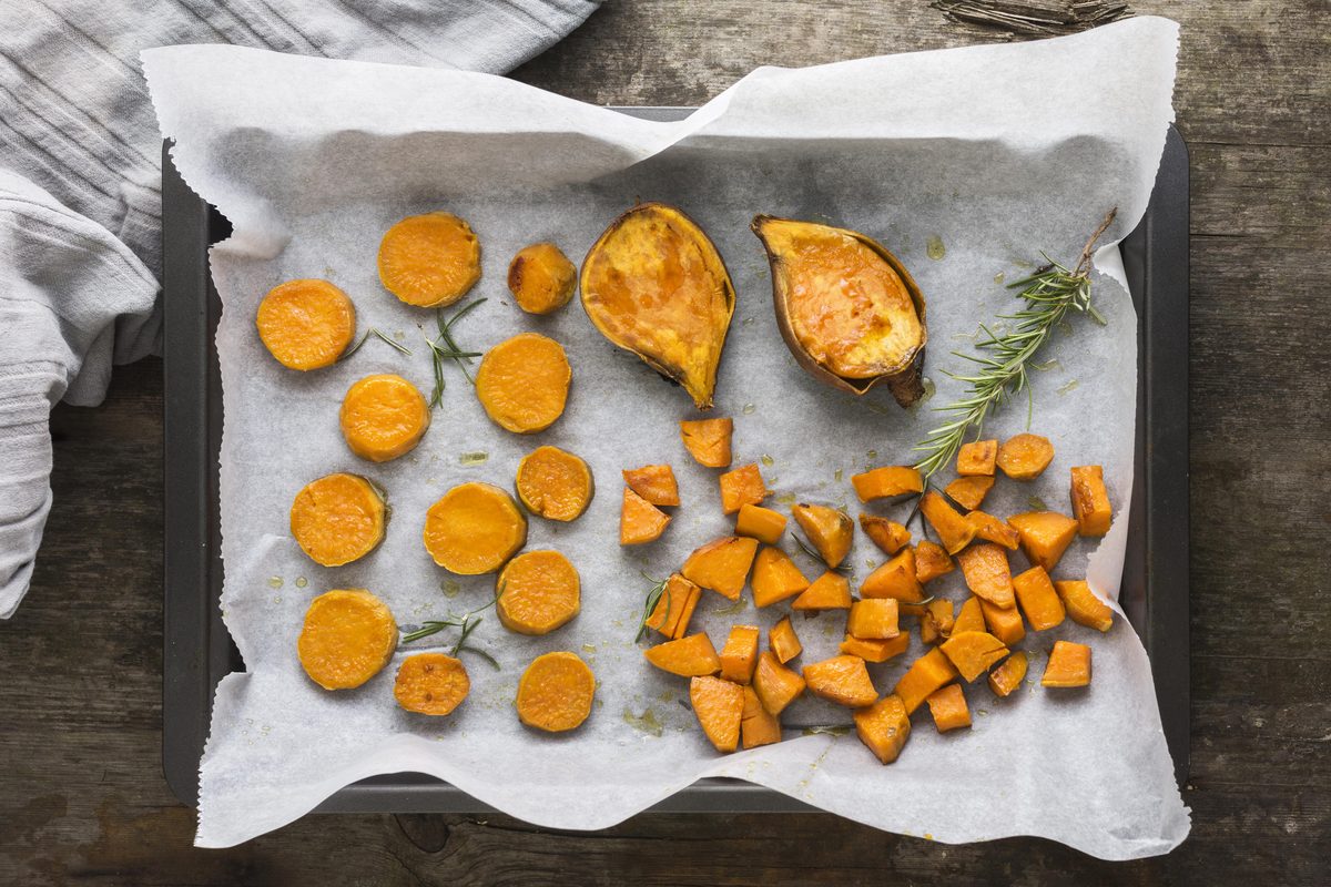 Roasted sweet potato slices on a baking tray