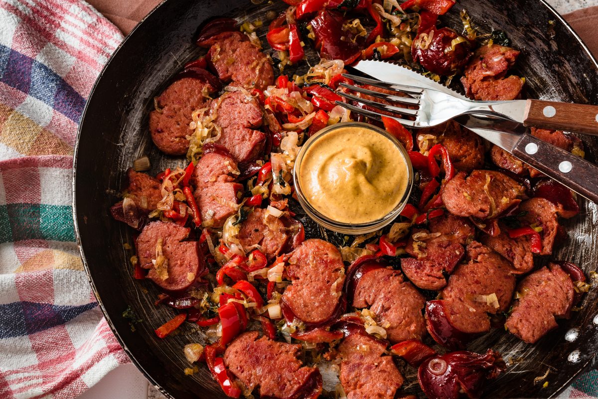 Slices of chorizo-style sausage pan-fried with peppers and onions