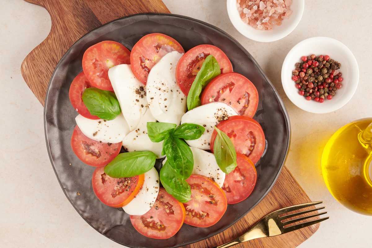 Caprese salad of tomatoes, mozzarella and fresh basil on a plate