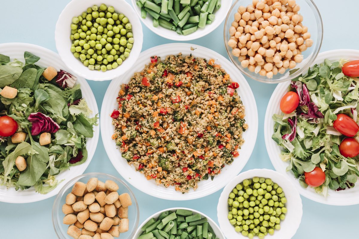 Salads of quinoa, chickpeas, peas and green beans in bowls