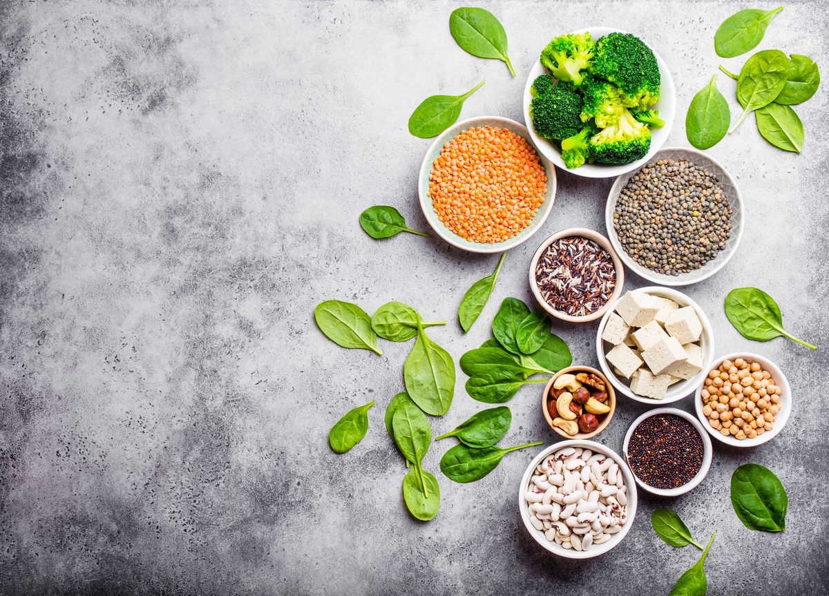 Plant protein sources in bowls: lentils, tofu, quinoa, chickpeas and beans