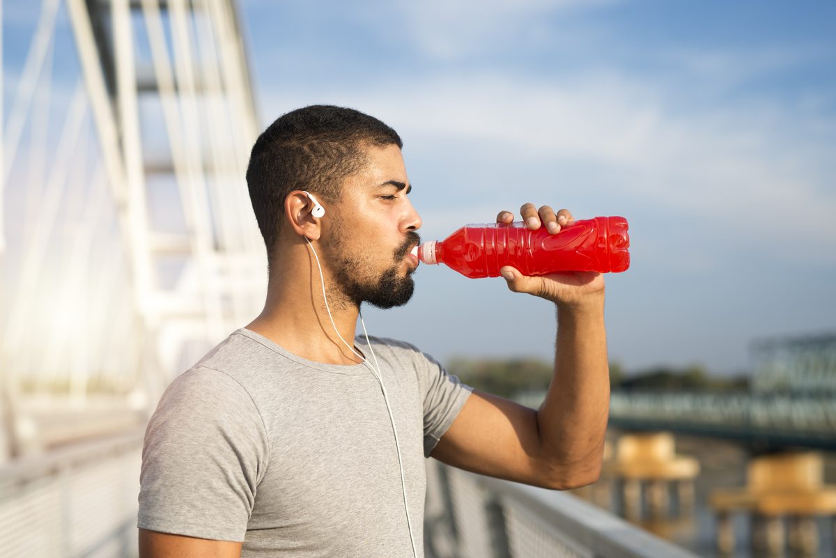 Athlete drinking a sports drink during an outdoor training session