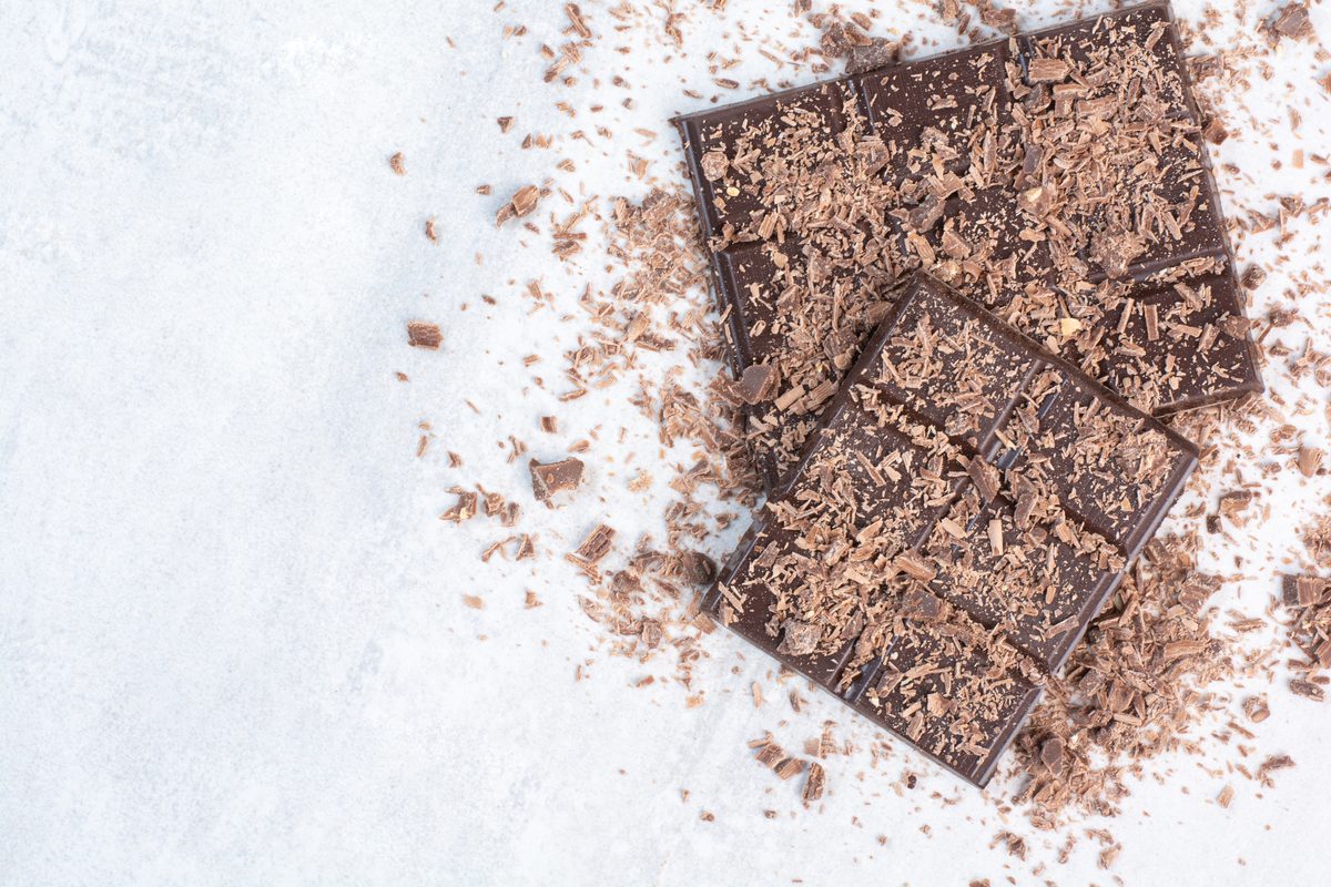 Dark chocolate bars covered in chocolate shavings