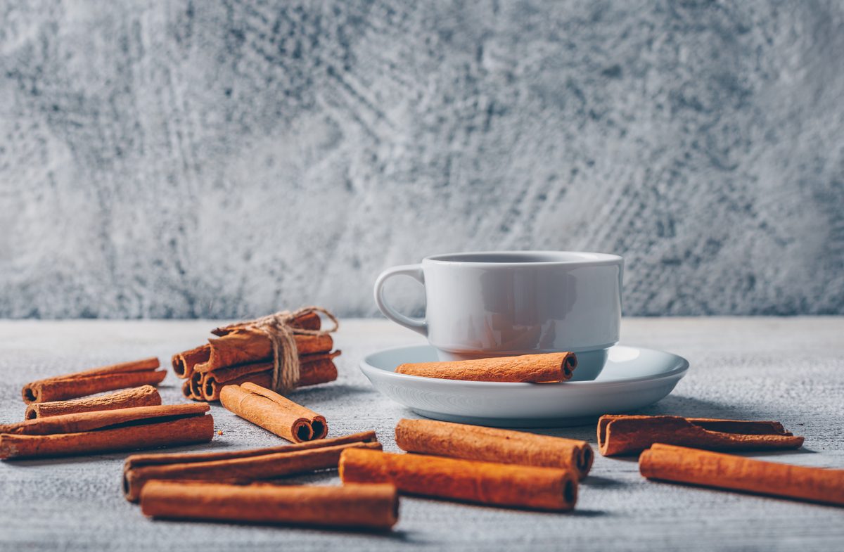Cup of hot tea with cinnamon sticks
