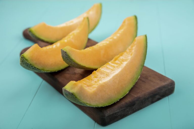 Slices of cantaloupe melon on a wooden board