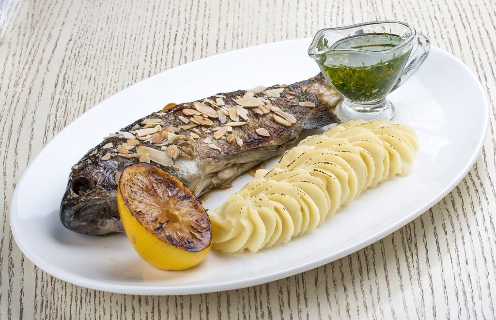 Oven-baked trout with flaked almonds and mashed potato