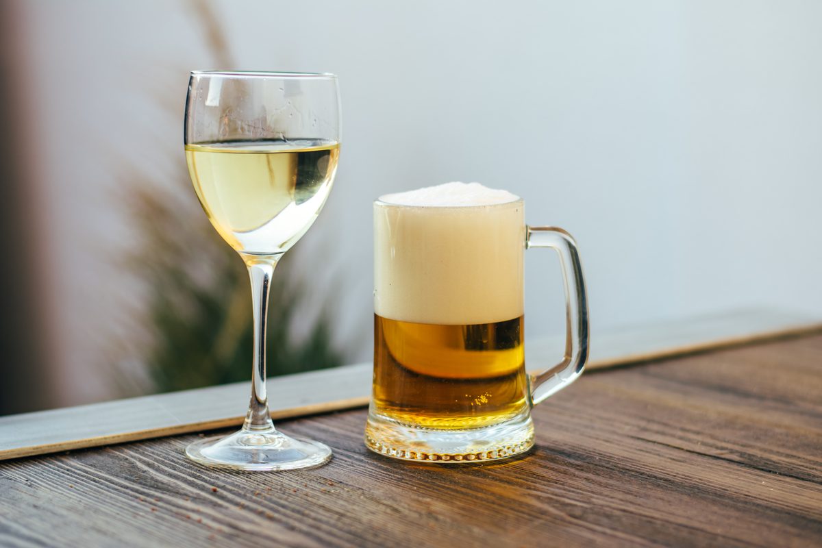 A glass of lager and a glass of white wine, two standard drinks