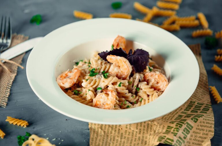 Plate of fusilli with prawns and fresh herbs