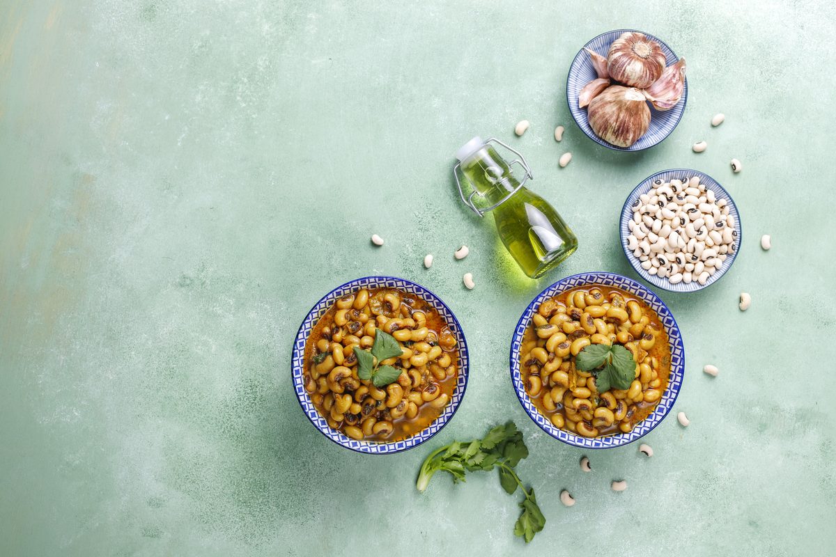 Bowls of black-eyed bean curry on a sea-green background
