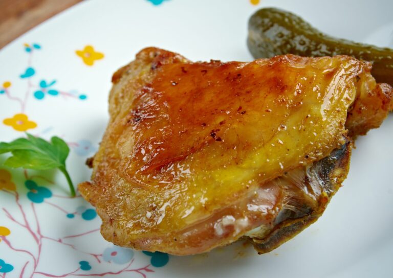 Golden piri-piri chicken leg served with a green chilli