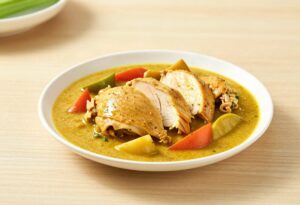 Sliced chicken with curry and vegetables